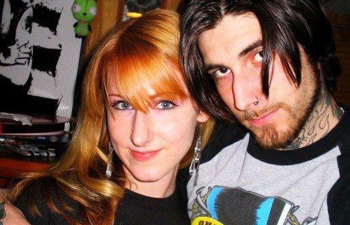 Banksy's Girlfriend Alexis Fallon Smith in a black top with Banksy in a grey Guns 'n Roses t-shirt